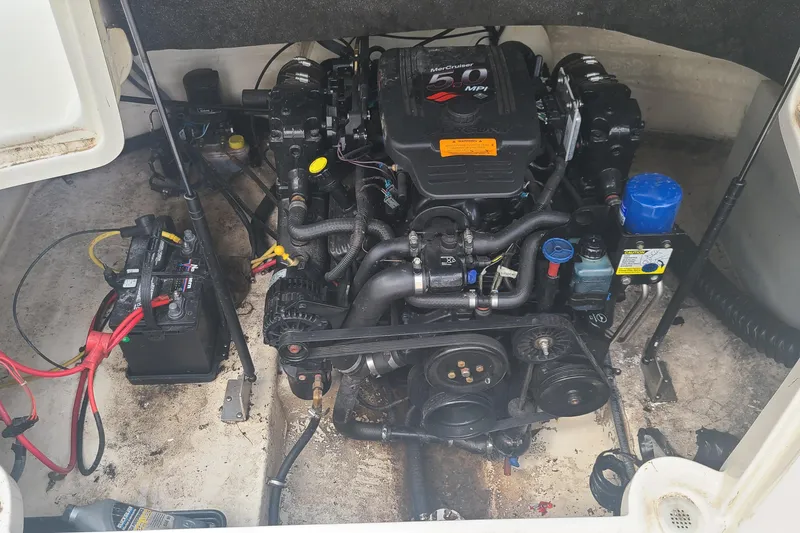 Slide: The Image of Engine compartment of a 2005 Chaparral 264 Sunesta boat, featuring a MerCruiser 5.0 MPI engine. - 9
