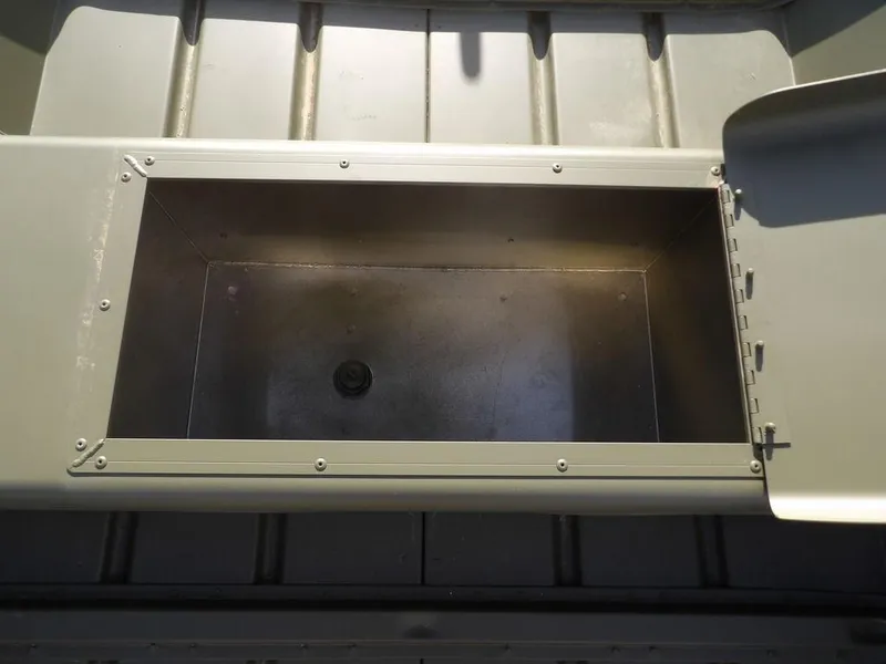 Slide: The Image of 2025 Crestliner 1648M CR Jon boat storage compartment, open lid, interior view. - 12