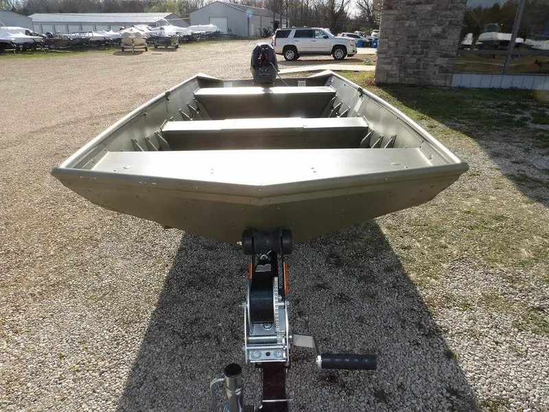 Slide: The Image of 2025 Crestliner 1648M CR Jon boat on trailer, parked outdoors on gravel. - 2