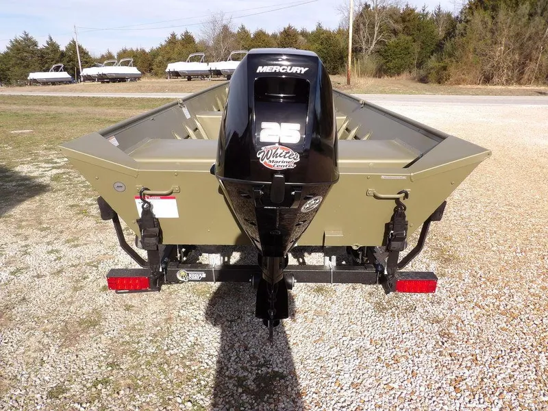 Slide: The Image of 2025 Crestliner 1648M CR Jon boat with Mercury 25 outboard motor, parked on gravel. - 6