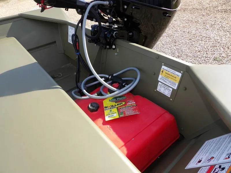 Slide: The Image of 2025 Crestliner 1648M CR Jon boat interior with red fuel tank and engine components. - 9