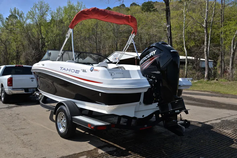 Slide: The Image of 2018 Tahoe 550 TS boat with Mercury engine on trailer, parked outdoors. - 12