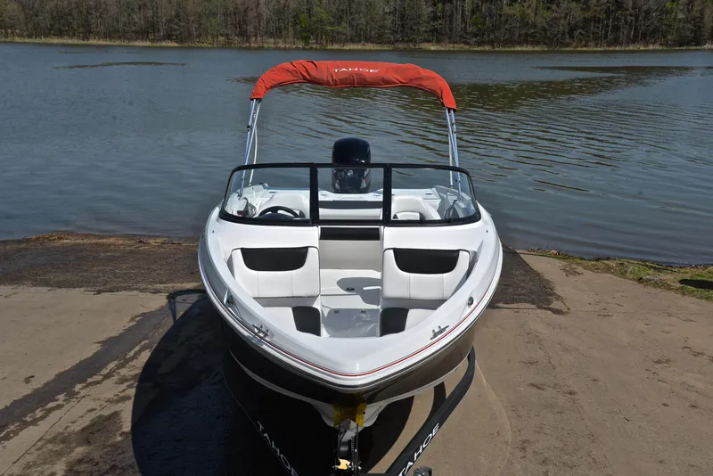Slide: The Image of 2018 Tahoe 550 TS boat with red canopy on a lake shore. - 17