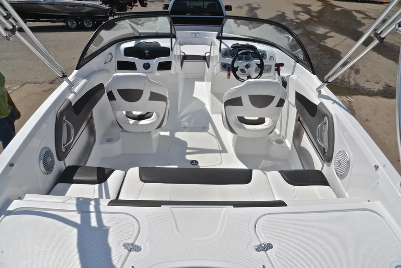 Slide: The Image of 2018 Tahoe 550 TS boat interior with white seating and steering console. - 18