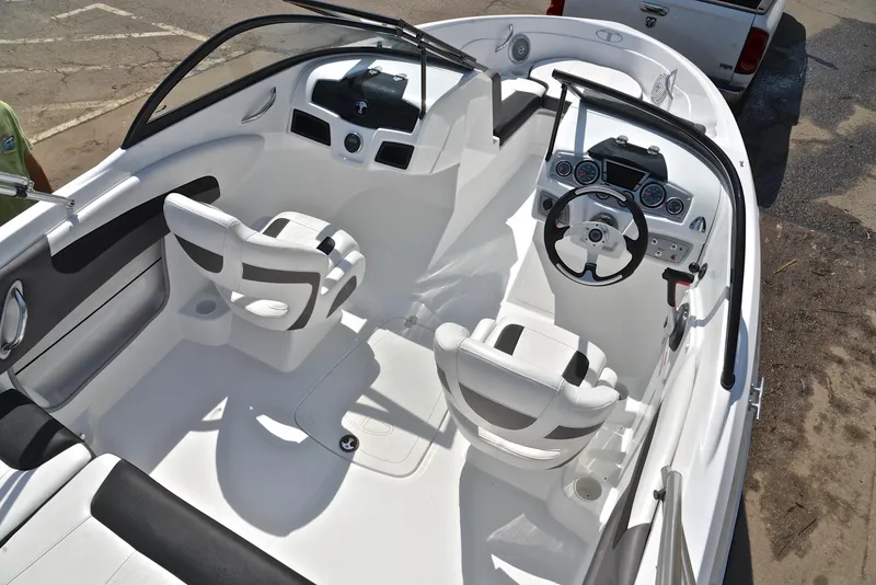 Slide: The Image of 2018 Tahoe 550 TS boat interior with dual seats and steering console. - 19