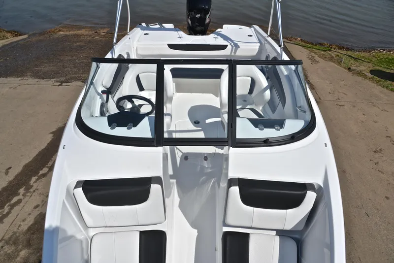 Slide: The Image of 2018 Tahoe 550 TS boat with white interior, docked by the water. - 20