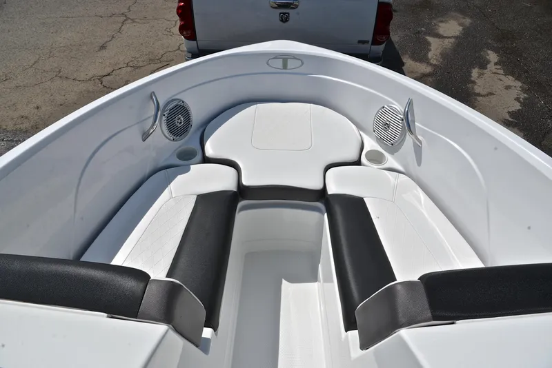 Slide: The Image of 2018 Tahoe 550 TS boat interior with white and black seating, featuring built-in speakers. - 21
