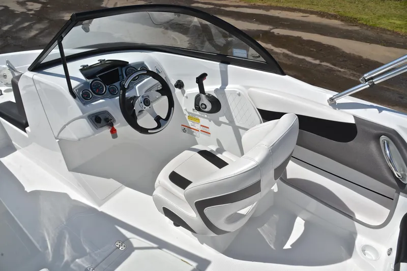 Slide: The Image of 2018 Tahoe 550 TS boat interior with steering wheel and seating. - 24