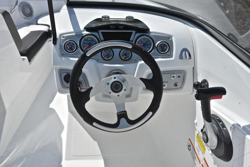 Slide: The Image of Steering console of a 2018 Tahoe 550 TS boat with gauges and controls. - 25