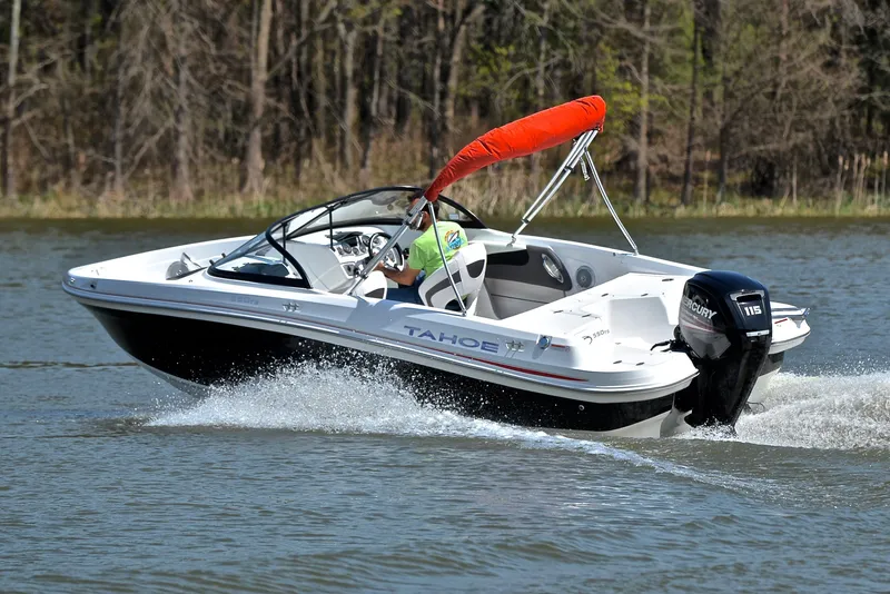Slide: The Image of 2018 Tahoe 550 TS boat cruising on a lake with outboard motor. - 6
