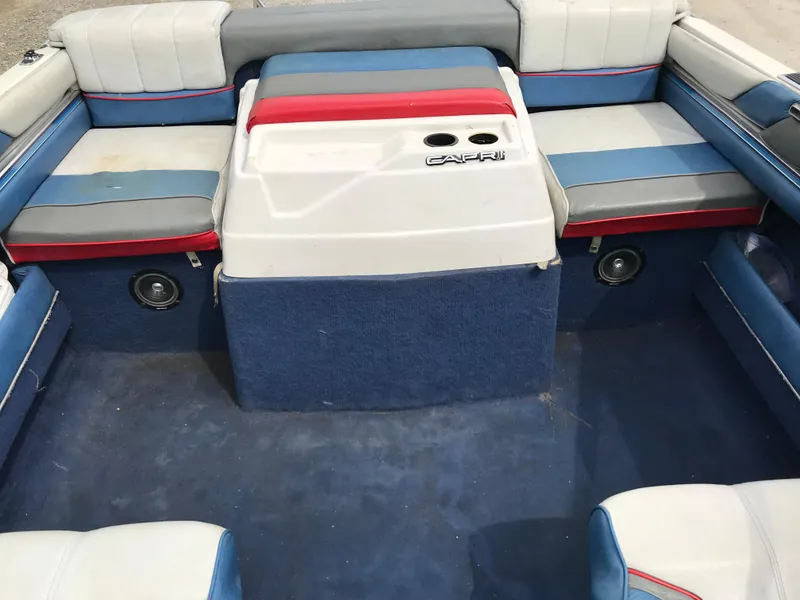 Slide: The Image of 1987 Bayliner 1950 Capri boat interior with blue, red, and white seating. - 10
