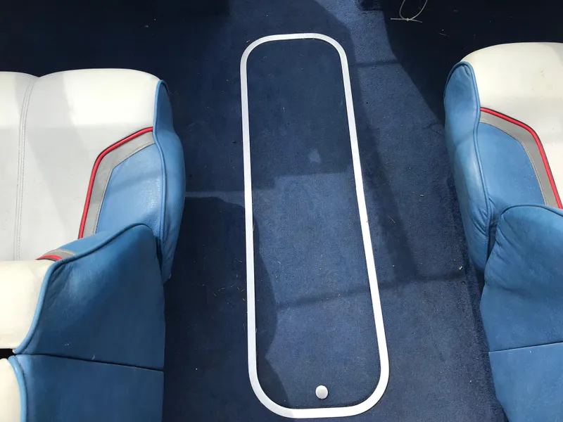Slide: The Image of Interior of 1987 Bayliner 1950 Capri boat with blue and white seating. - 16