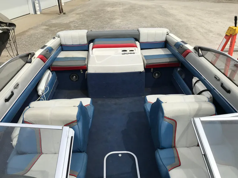Slide: The Image of 1987 Bayliner 1950 Capri boat interior with blue and white seating, open layout, and clean design. - 17