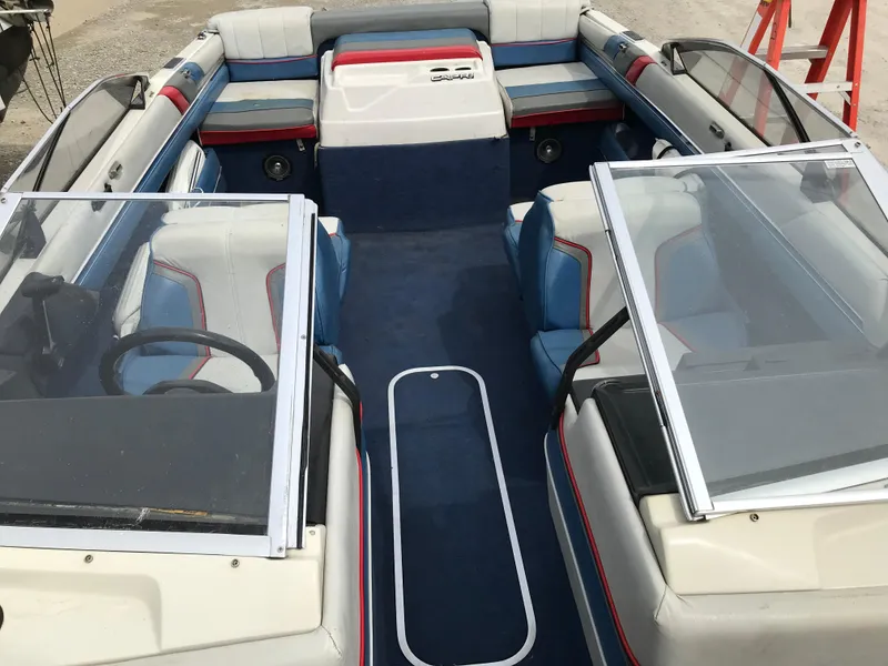 Slide: The Image of 1987 Bayliner 1950 Capri boat interior with blue and white seating, open windshield. - 18