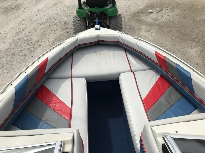 Slide: The Image of 1987 Bayliner 1950 Capri boat interior with red, blue, and gray seating. - 19
