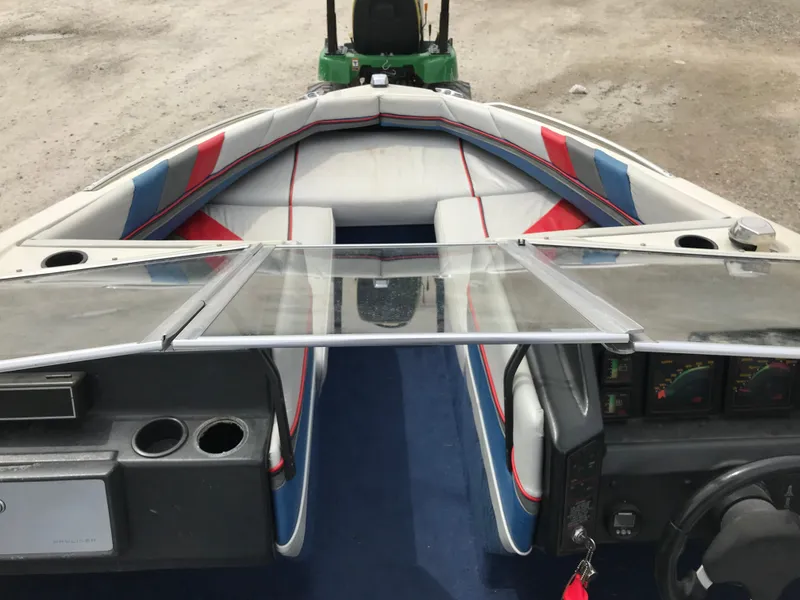 Slide: The Image of 1987 Bayliner 1950 Capri boat interior with blue, red, and white seating. - 20