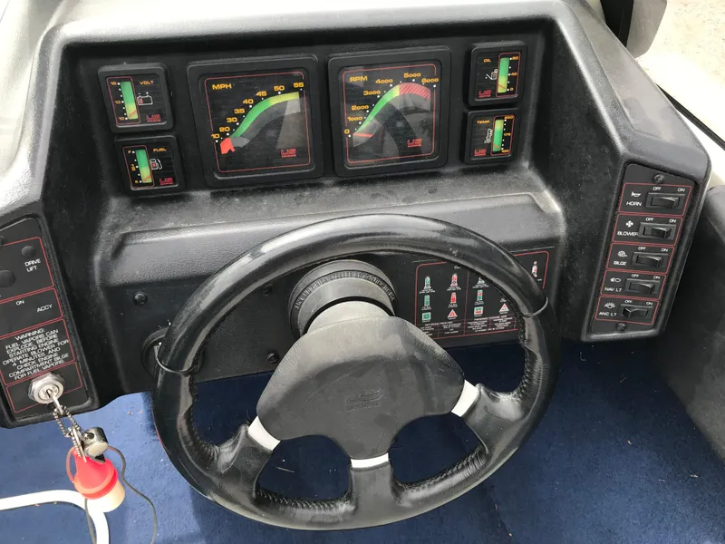 Slide: The Image of Dashboard of a 1987 Bayliner 1950 Capri boat with steering wheel and instrument panel. - 21