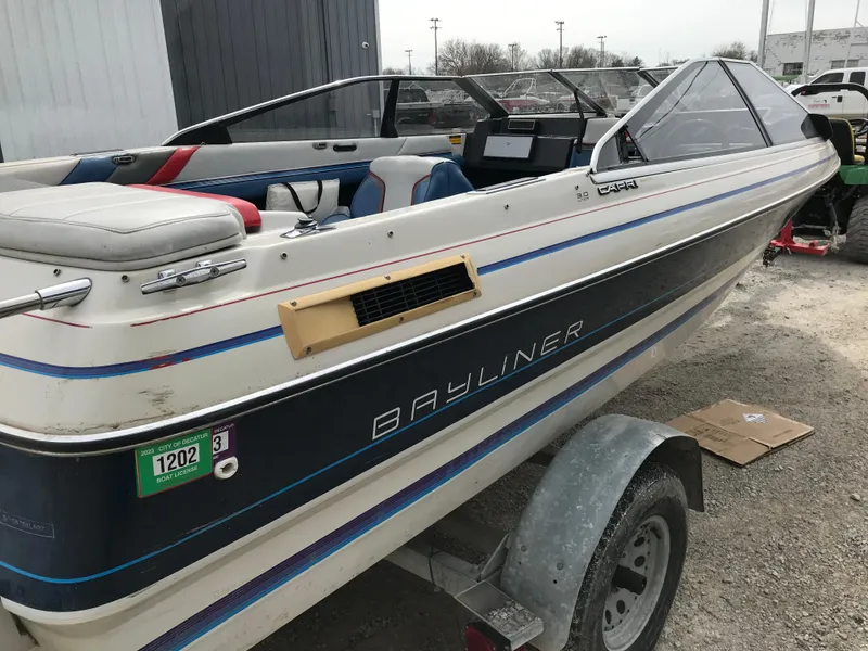 Slide: The Image of 1987 Bayliner 1950 Capri boat on trailer, featuring sleek design and classic styling. - 24