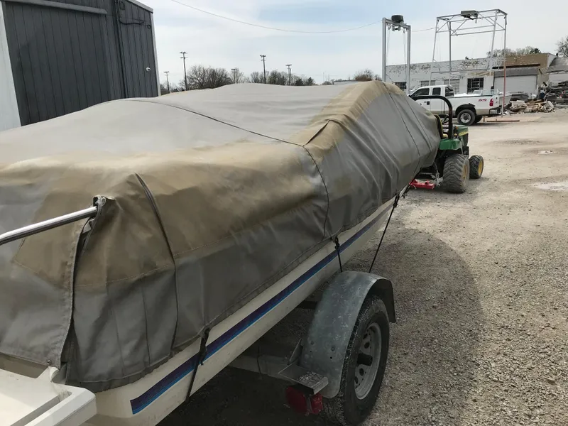 Slide: The Image of Covered 1987 Bayliner 1950 Capri boat on trailer in outdoor setting. - 29