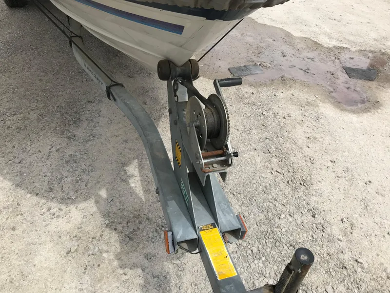 Slide: The Image of 1987 Bayliner 1950 Capri boat on trailer, showing winch and hitch. - 35