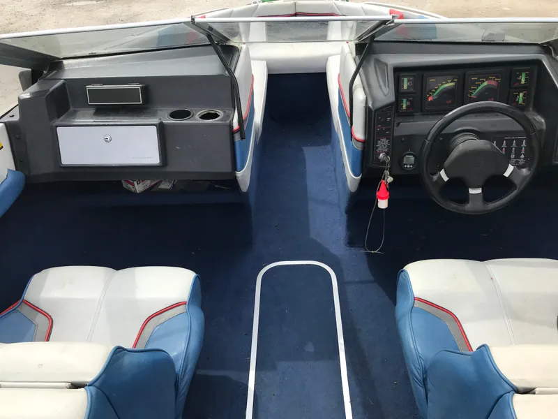 Slide: The Image of Interior of a 1987 Bayliner 1950 Capri boat with blue and white seating. - 8