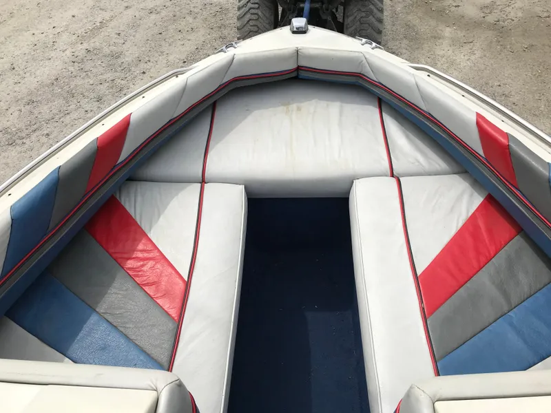 Slide: The Image of 1987 Bayliner 1950 Capri boat interior with colorful upholstery design. - 9