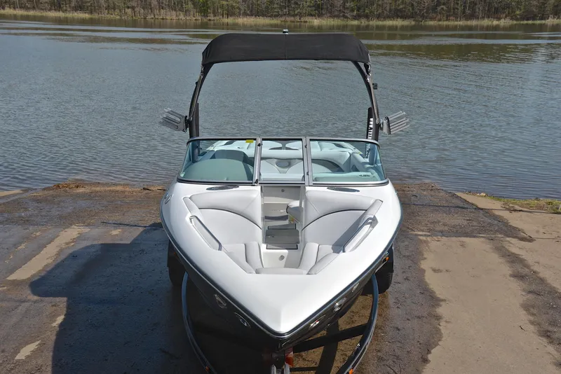 Slide: The Image of 2012 Centurion ELITE C4 boat on a ramp by a lake. - 17