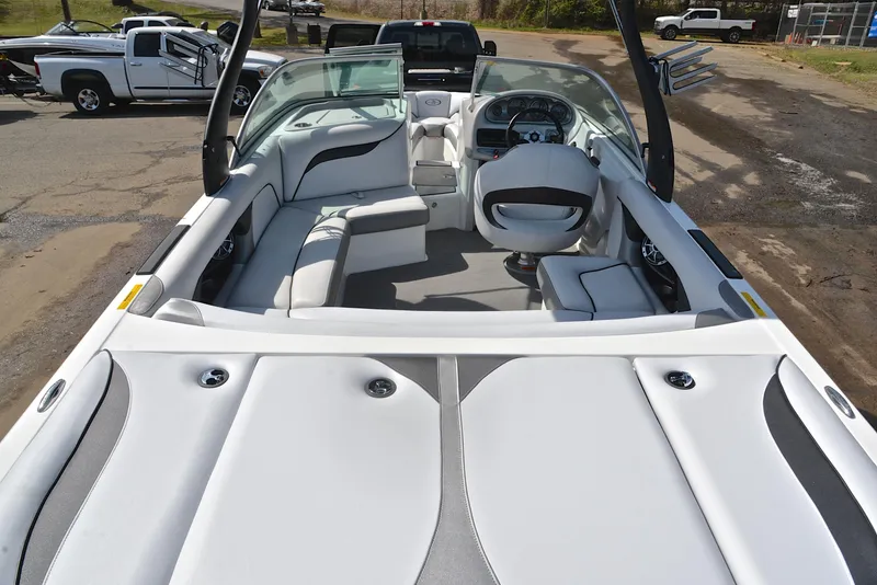 Slide: The Image of 2012 Centurion ELITE C4 boat interior with seating and steering wheel, parked on a trailer. - 18