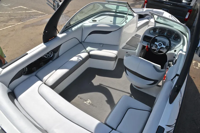 Slide: The Image of Interior of a 2012 Centurion ELITE C4 boat with white seating and dashboard. - 19