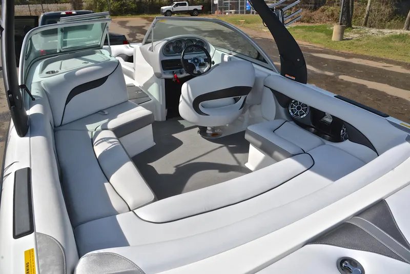 Slide: The Image of Interior of a 2012 Centurion ELITE C4 boat with white seating and modern dashboard. - 23