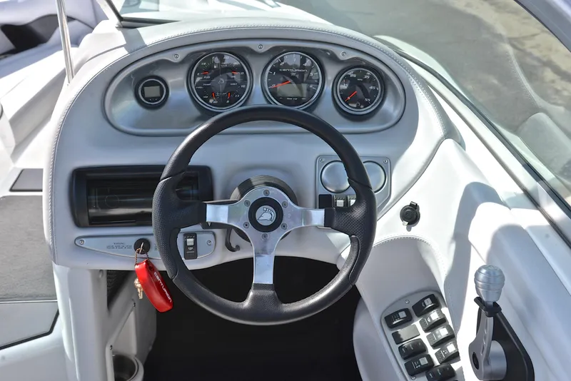 Slide: The Image of Steering wheel and dashboard of 2012 Centurion ELITE C4 boat with gauges and controls. - 25