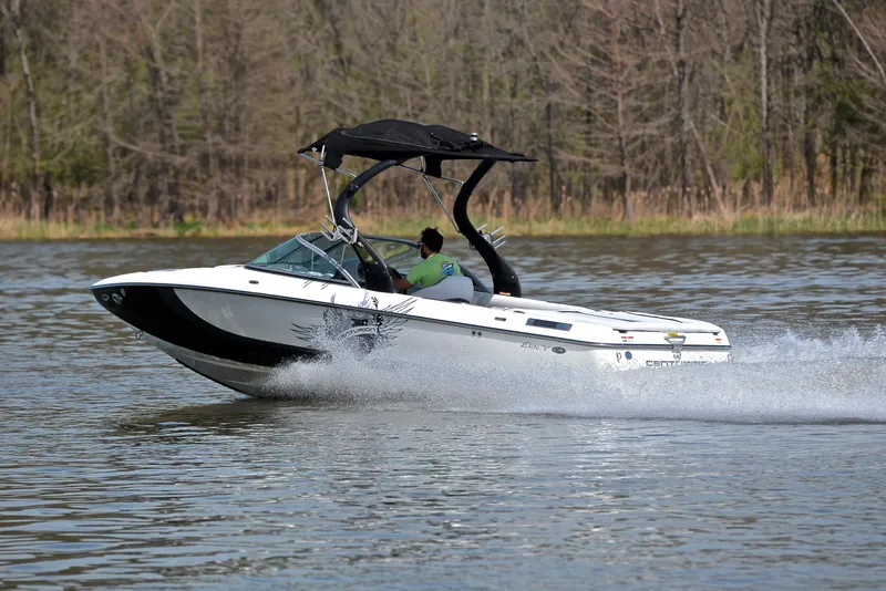 Slide: The Image of 2012 Centurion ELITE C4 speedboat cruising on a lake with trees in the background. - 4