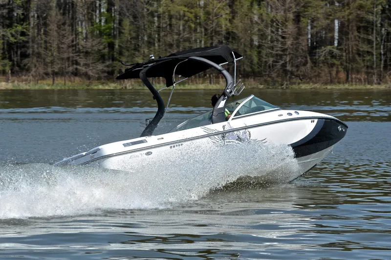 Slide: The Image of 2012 Centurion ELITE C4 speedboat cruising on a lake with trees in the background. - 5