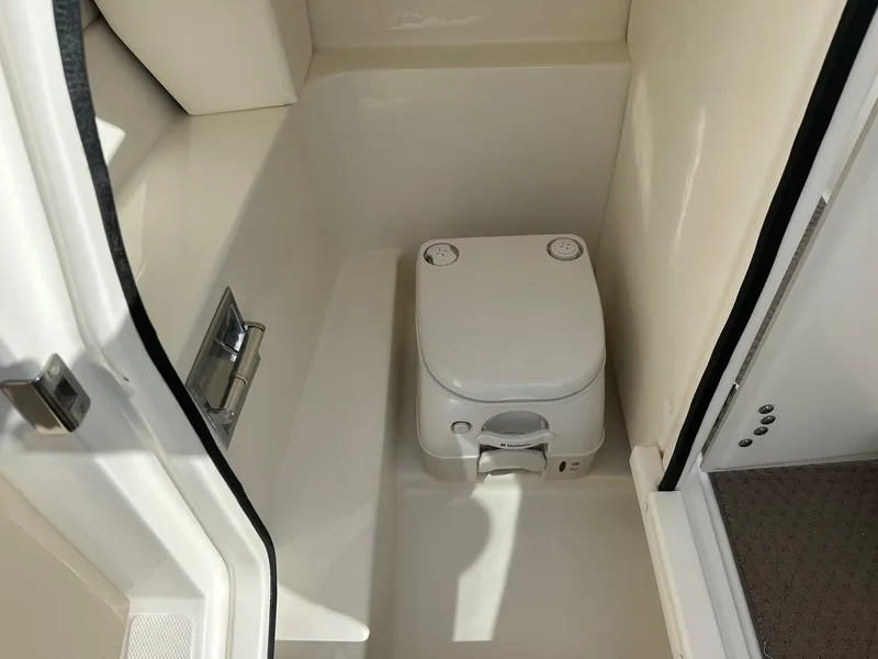 Slide: The Image of Compact marine toilet in a 2011 Sea Ray 250 SLX boat cabin. - 10