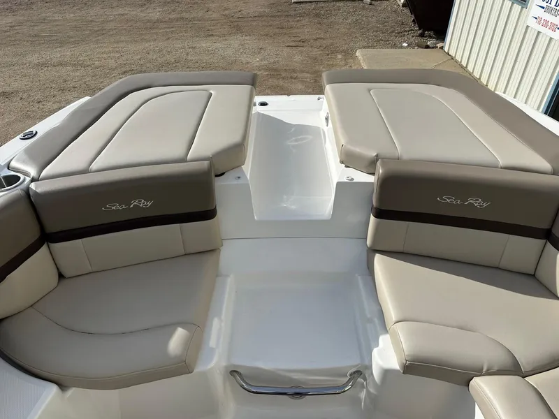 Slide: The Image of 2011 Sea Ray 250 SLX boat interior with beige seating and logo. - 12