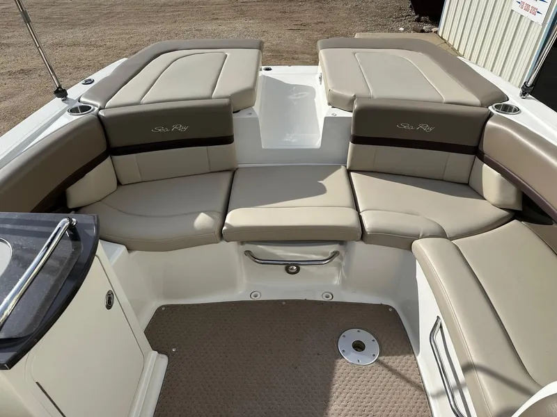 Slide: The Image of 2011 Sea Ray 250 SLX boat interior with beige seating and carpeted floor. - 15