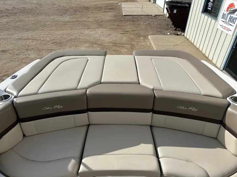 Slide: The Image of 2011 Sea Ray 250 SLX boat interior with beige seating and cup holders. - 16