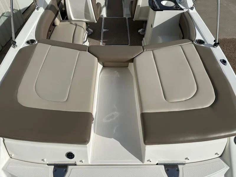 Slide: The Image of 2011 Sea Ray 250 SLX boat interior with beige seating and cup holders. - 17