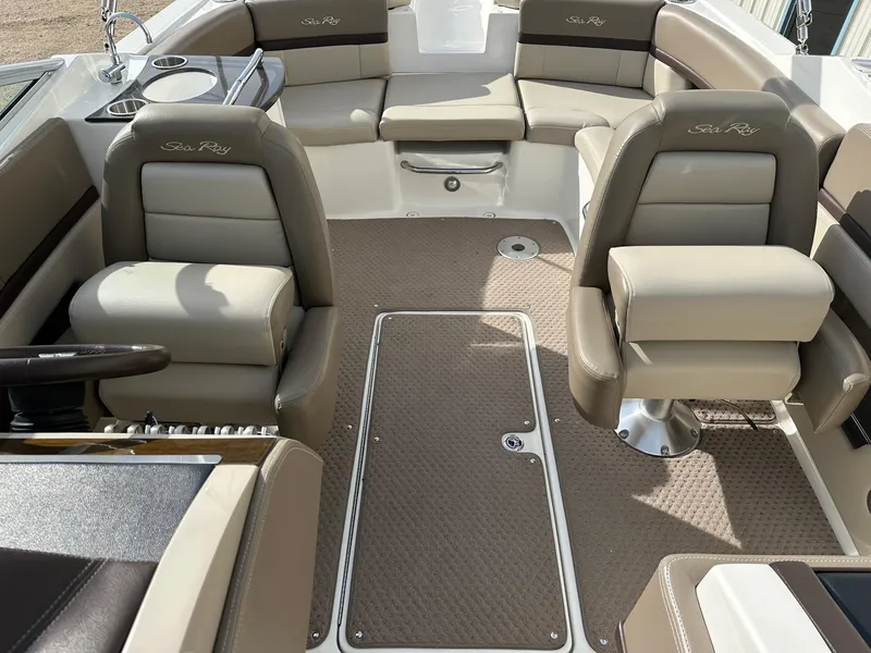 Slide: The Image of Interior of a 2011 Sea Ray 250 SLX boat with beige seating and carpet. - 18