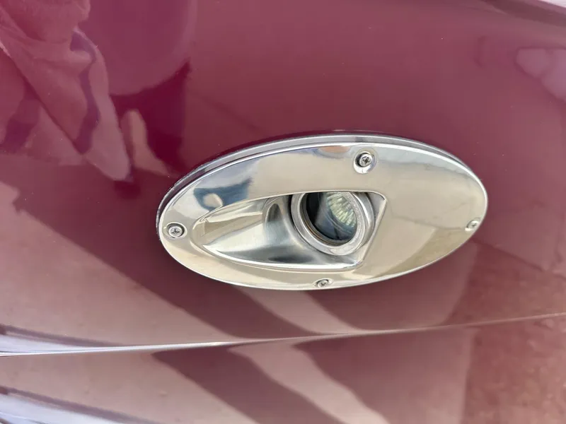 Slide: The Image of Close-up of a 2011 Sea Ray 250 SLX boat's chrome light fixture. - 2