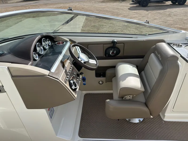 Slide: The Image of 2011 Sea Ray 250 SLX boat cockpit with steering wheel and gauges. - 20