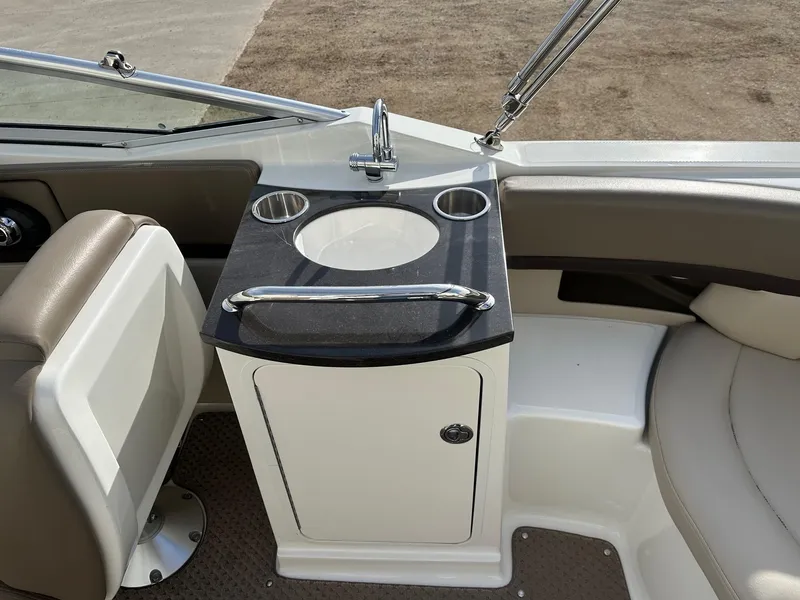 Slide: The Image of Interior of 2011 Sea Ray 250 SLX boat with sink and seating area. - 22