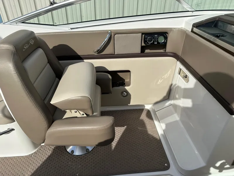 Slide: The Image of Interior of a 2011 Sea Ray 250 SLX boat with beige seating and control panel. - 25
