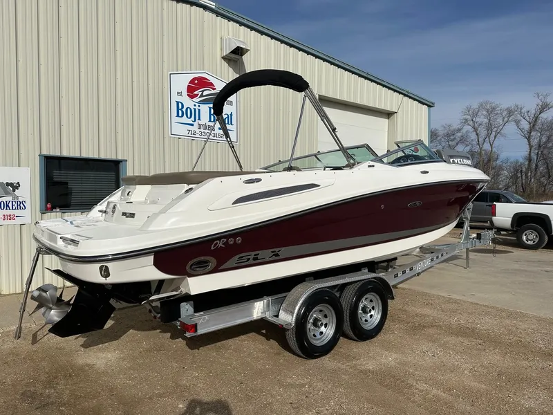 Slide: The Image of 2011 Sea Ray 250 SLX boat on trailer outside Boji Boat Brokers building. - 3