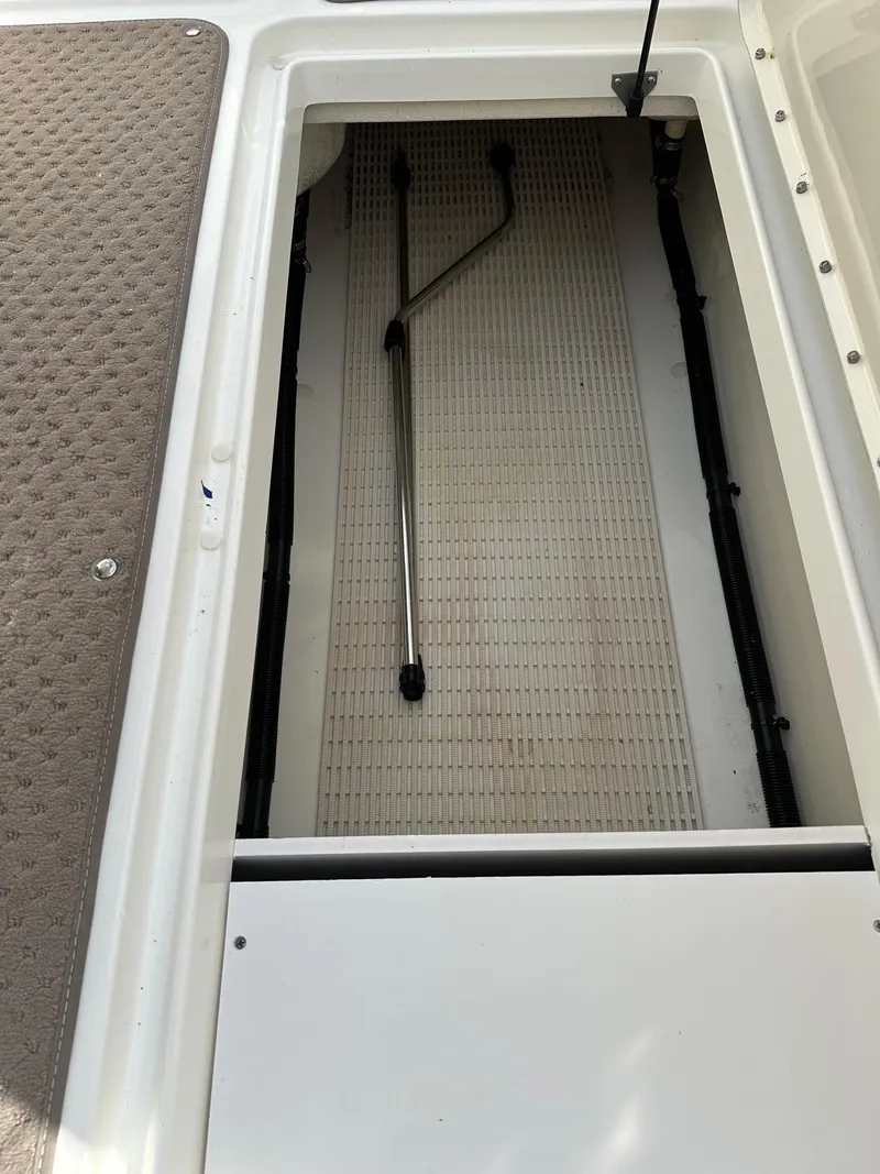 Slide: The Image of Storage compartment of a 2011 Sea Ray 250 SLX boat, featuring a clean interior. - 31
