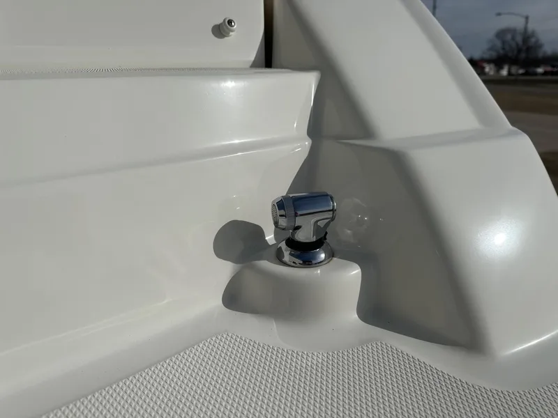 Slide: The Image of Close-up of a 2011 Sea Ray 250 SLX boat's chrome fitting on white surface. - 32