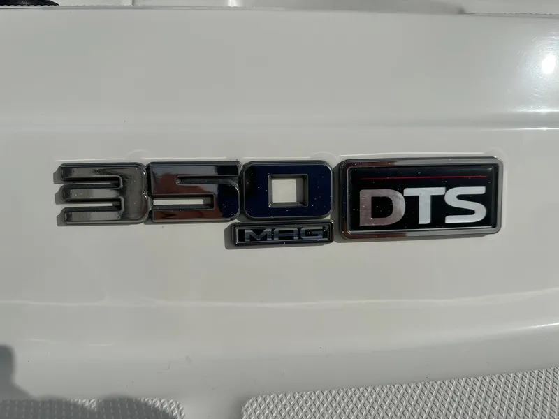 Slide: The Image of 2011 Sea Ray 250 SLX boat emblem displaying '350 MAG DTS' on white surface. - 33