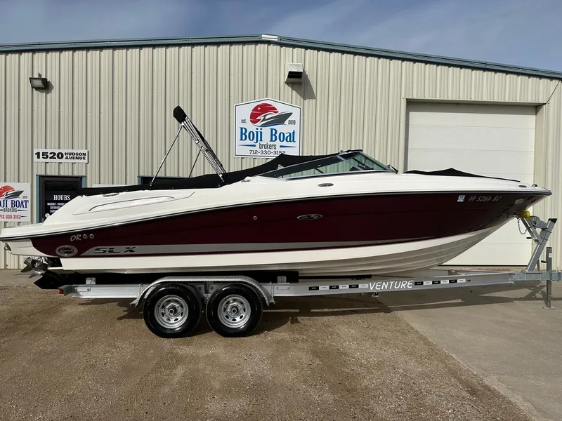 Slide: The Image of 2011 Sea Ray 250 SLX boat on trailer outside Boji Boat building. - 34