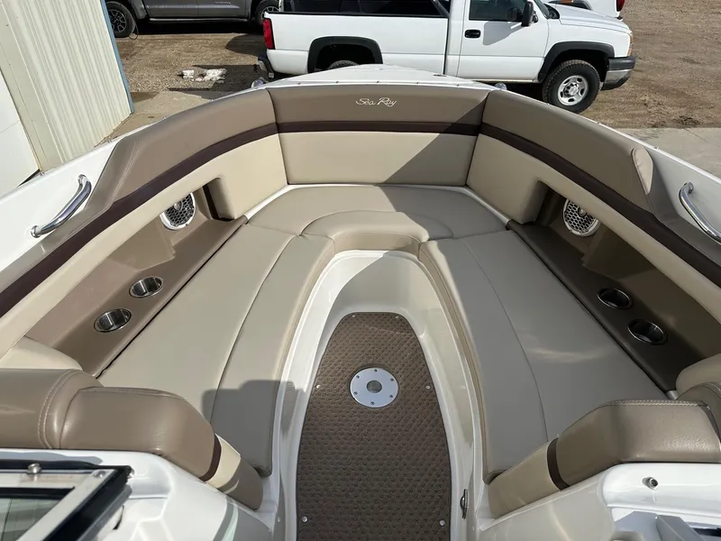 Slide: The Image of 2011 Sea Ray 250 SLX boat interior with beige seating and cup holders. - 7