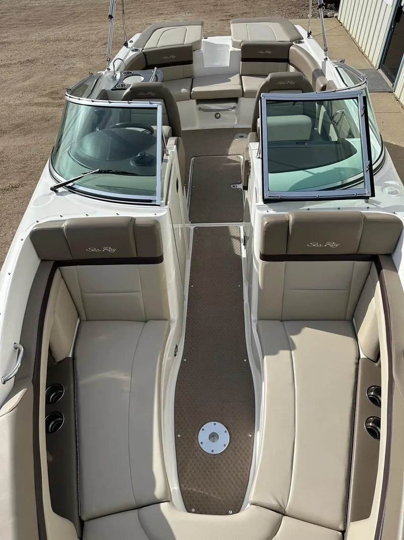 Slide: The Image of 2011 Sea Ray 250 SLX boat interior with beige seating and open windshield. - 8